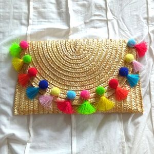 Straw clutch with pom pom fringe tassel detail